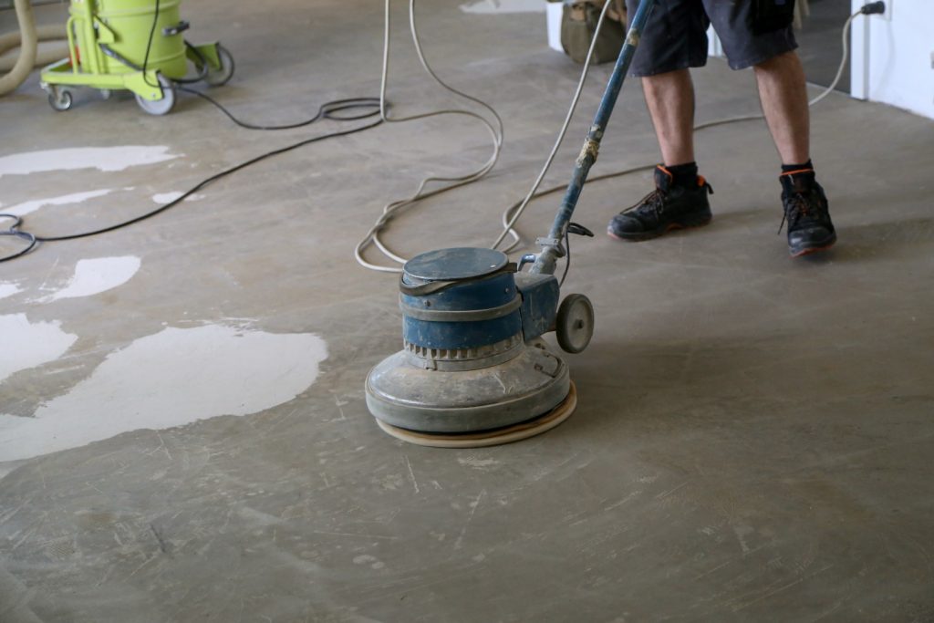picture of a worker buffing a floor with special equipment