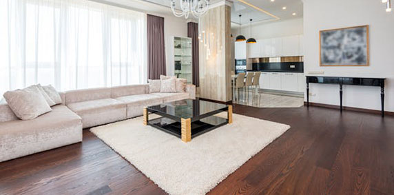 Luxury apartment interior featuring modern furniture against sleek white walls, creating a sophisticated and airy atmosphere.